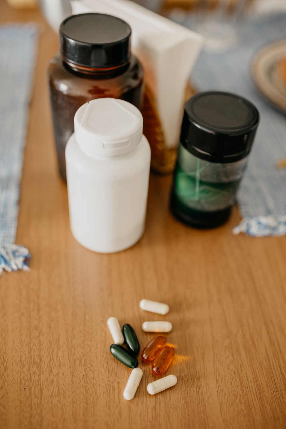 Assorted supplement bottles and capsules on a table — comparing the best bladder control supplements for women
